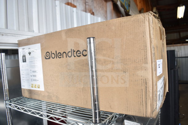 Blendtec Connoisseur 825 blender in original box with brand label. Box shows signs of wear. Includes sound enclosure and two WildSide+ jars.