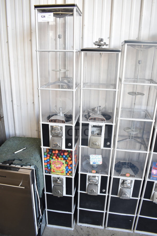 Five double stack vending machines with clear panels, coin slots, and labels for gum, sour sweets, in good condition.