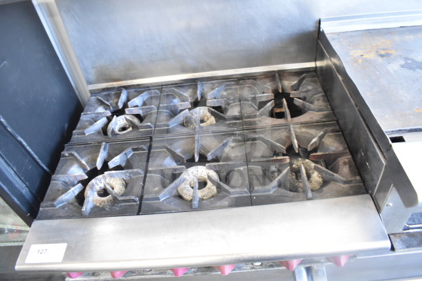 American Range commercial gas-powered range with 6 burners, flat top griddle, 2 ovens, over shelf, backsplash, casters.