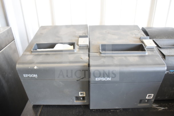 Five receipt printers, including Epson and Star TSP100III models, used condition. Visible wear on surfaces.