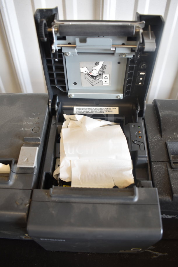 Five receipt printers, including Epson and Star TSP100III models. Condition unknown; visible wear and internal paper jams.
