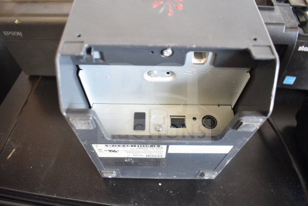 Five receipt printers including Epson and Star TSP100III shown. Visible ports and labels. Overall good condition.