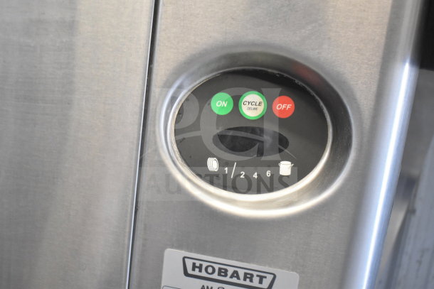 Hobart AM15 Commercial Dishwasher control panel with on/off buttons and cycle settings, labeled with model info.