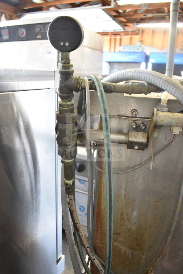Hobart AM15 commercial corner pass through dishwasher, 208-240V, 3-phase. Used, visible wear and attached hoses.