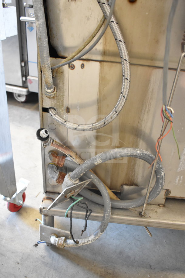 Hobart AM15 commercial dishwasher rear view, showing electrical wires and plumbing connections, in used condition.