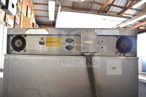 CreCor Commercial Heated Holding Cabinet with casters. Visible Model #UH18-671-120. Shows wear and signs of use.