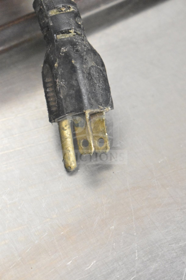 Close-up of a worn power plug for a Baxter SP155G-M1826 commercial floor-style natural gas donut fryer.