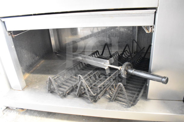 Fri-jado TDR 7-P electric rotisserie oven on casters, 208V, 3 phase. Interior view shows rotisserie racks and skewers.