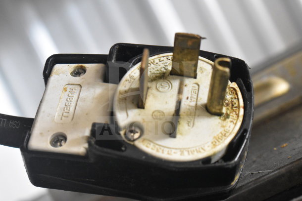 Close-up of a Fri-jado TDR 7-P rotisserie oven plug, showing three-prong design and Hubbell branding on the casing.