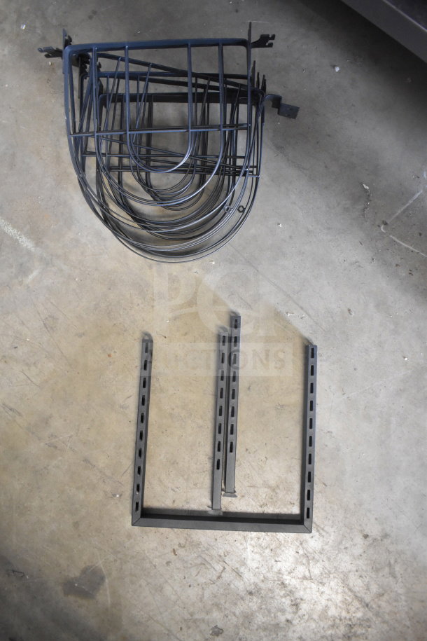 Lot of various metal racks, black finish, includes multiple curved and vertical pieces, suitable for storage solutions.