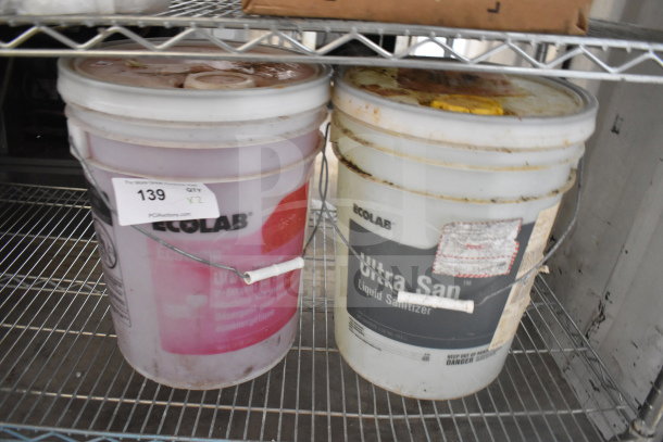 Two Ecolab barrels on a shelf; Ultra Klene Detergent and Ultra San Liquid Sanitizer. Auction tag indicating "2 Times Your Bid."