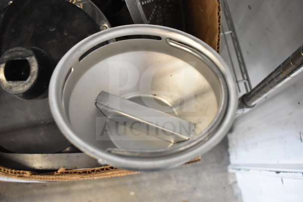 Box of various metal food processor blades, includes different shapes and sizes, used condition, some visible wear.