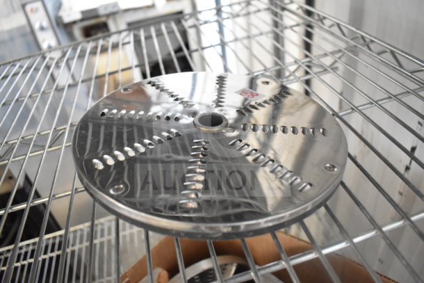 Food processor blade on metal rack, showing shiny, perforated surface. Blade appears in good condition. Auction lot of 20.