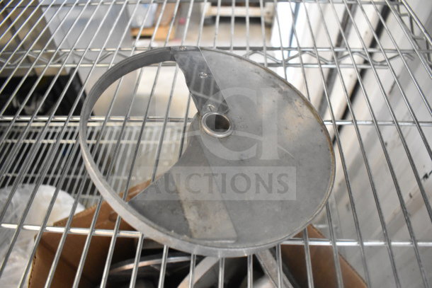 Food processor blade on metal rack, circular design, slight wear, marked "812". Part of 20-item auction lot.
