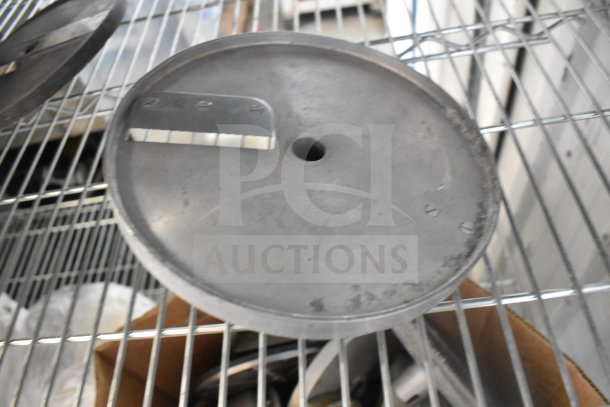 20 various metal discs for food processors, used condition, includes sharp blades, on metal shelving for auction.