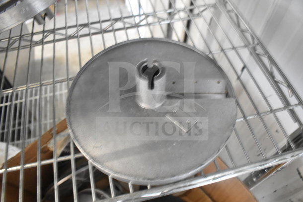 Metal food processor blade on metal shelf; part of a lot of 20 various items in good condition, enhancing auction value.