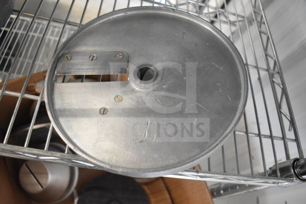 Steel food processor blade, circular with central hole, three screws, on wire rack. Part of a 20-item lot, good condition.