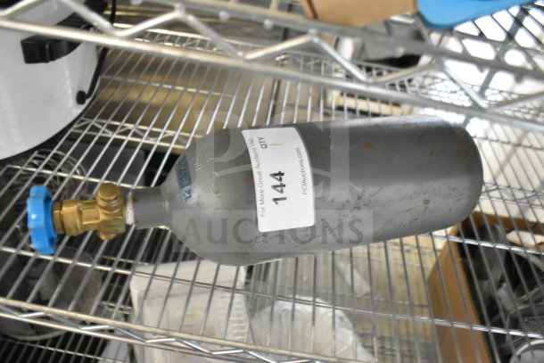 Carbon Dioxide Tank, moderate wear, brass valve, blue handle, label with auction info. Buyer must pick up.