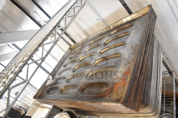 Auction lot featuring a tier of stacked metal baking pans in used condition on a metal shelf.