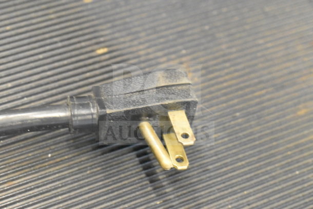 Power plug for 2017 True T-35 commercial cooler, 115 volts, 1 phase, black with three prongs, slight wear visible.