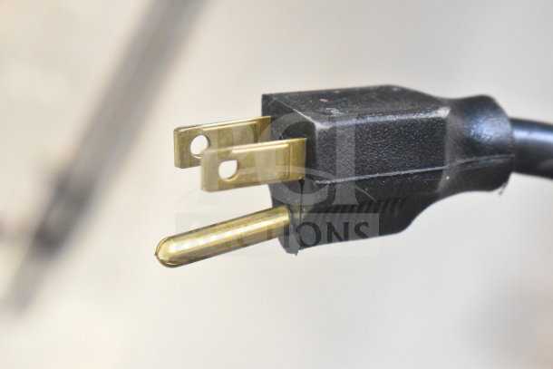 Hilliard's Floor Style Chocolate System plug, 120 volts, 1 phase, black with brass prongs, in good condition.