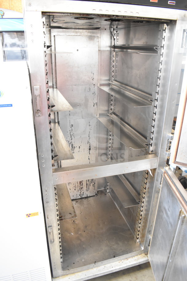 Commercial heated holding cabinet HU18-671-120 on casters, stainless steel, interior racks, visible wear, ideal for restaurant use.