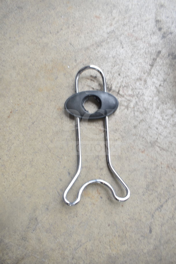 Metal attachment with black plastic lock for securing a KitchenAid mixer bowl.