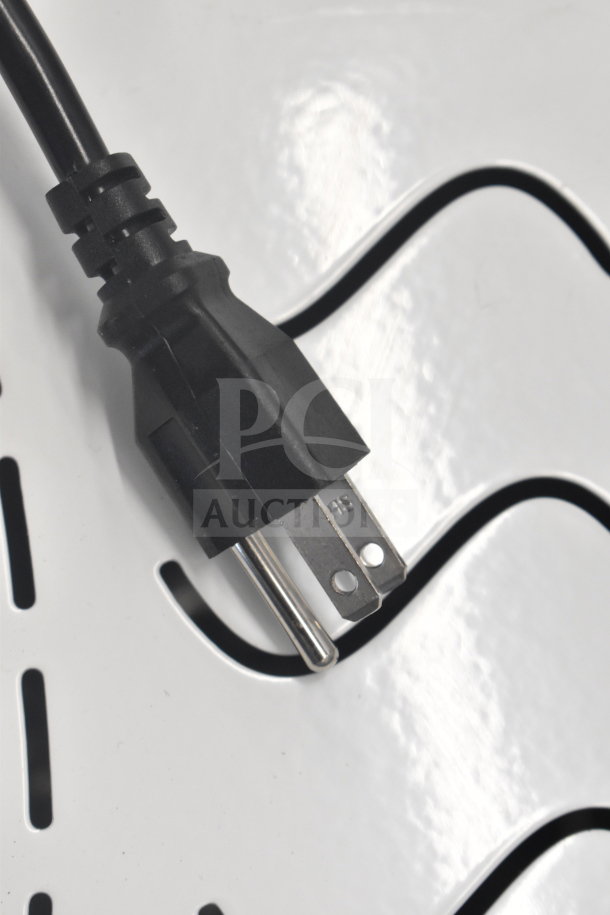 Black power plug of a commercial steam milk frother, 110 volts, dual head edition, indicating single phase use.