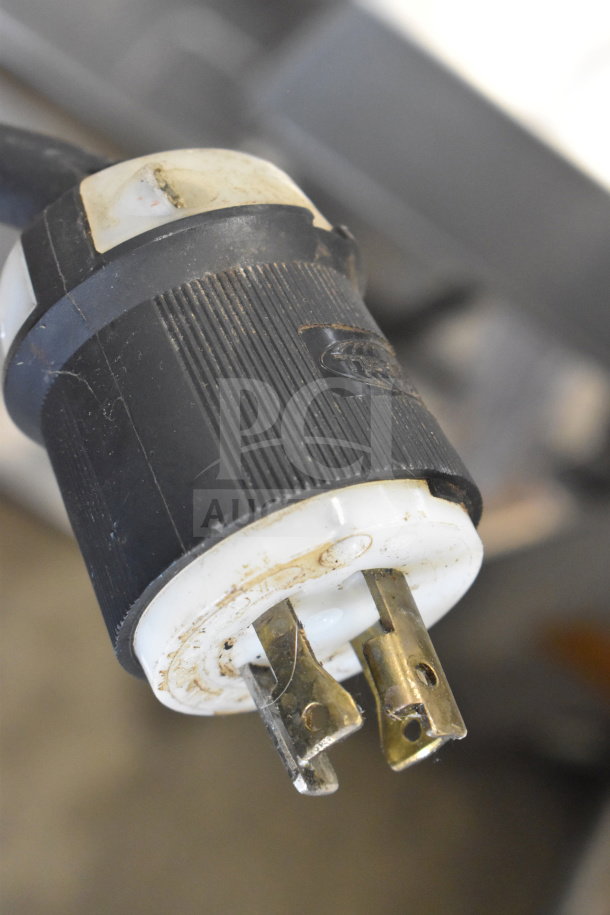 Close-up of a plug on a Bunn IC3 commercial countertop iced tea machine, showing wear and discoloration.