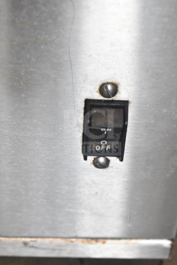 Bunn IC3 commercial countertop iced tea machine switch, showing on/off controls. Visible metal exterior, used condition.