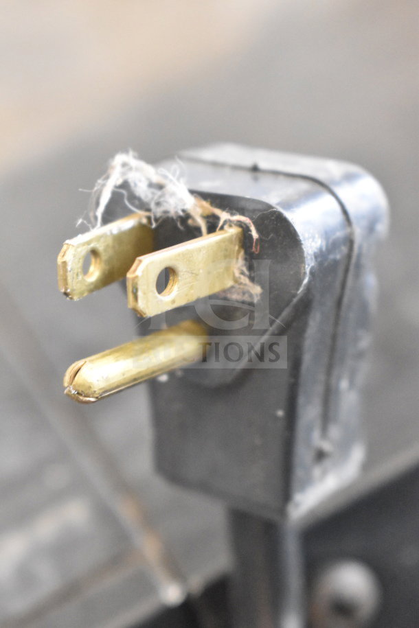 Close-up image of a worn electrical plug from a Habco ESM10 cooler, showing frayed wiring and bent prongs.