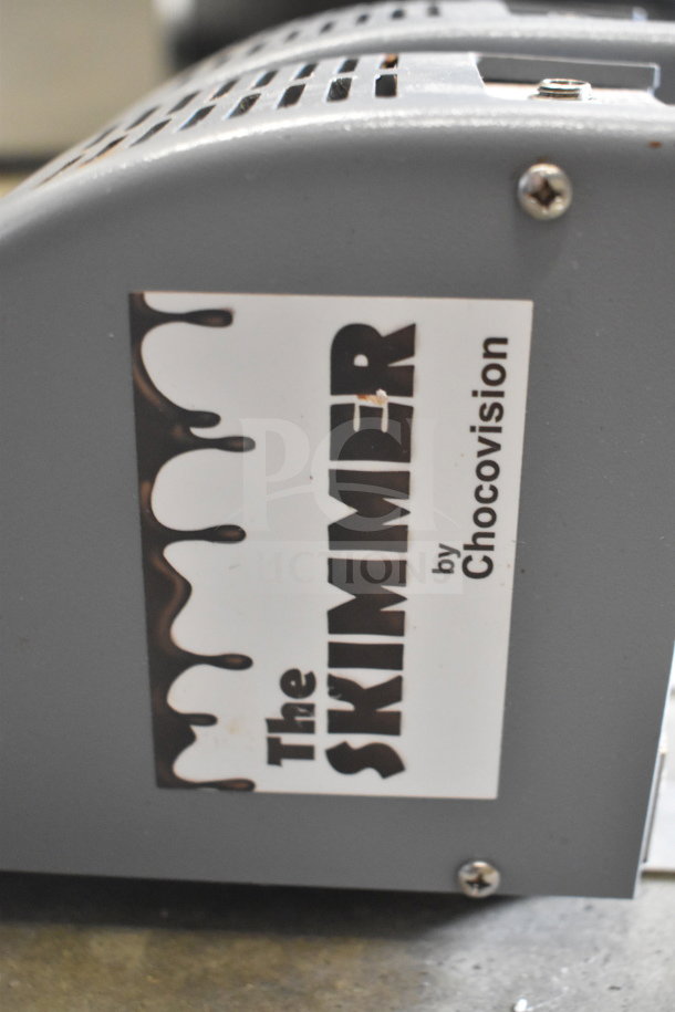 ChocoVision Revolation X3210 Chocolate Tempering Machine, 110V, 1 Phase, gray finish, features "The Skimmer" label.