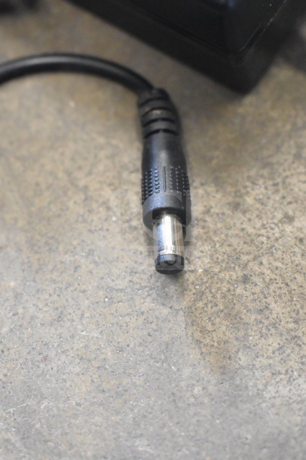 A close-up of a black power connector plug for the ChocoVision Revolation X3210 Chocolate Tempering Machine.