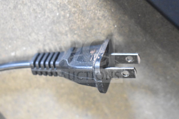Close-up of a standard 110V power plug for a ChocoVision Revolation X3210 Chocolate Tempering Machine.