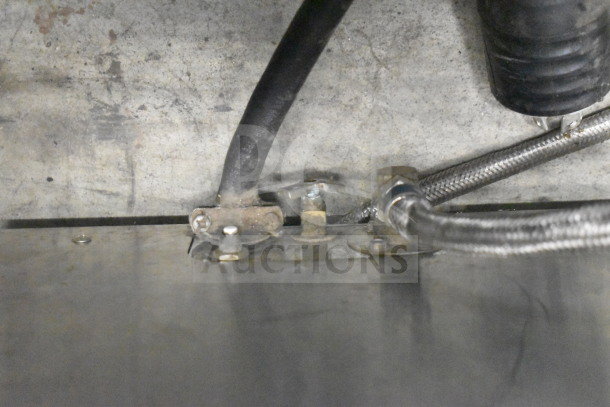 Fetco CBS-32Aap Commercial Coffee Machine, dual setup, shows underside wiring and hoses; check for wear or maintenance.