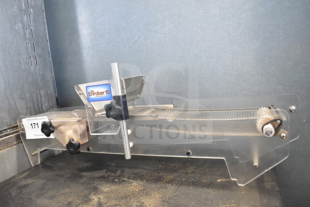 Chocovision Enrober 10 for Revolation Delta Chocolate Temperer, includes conveyor system, transparent and metal components, label visible.