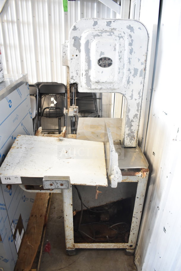 Hobart commercial floor style meat saw, metal construction, visible wear and rust, branded logo on upper panel.
