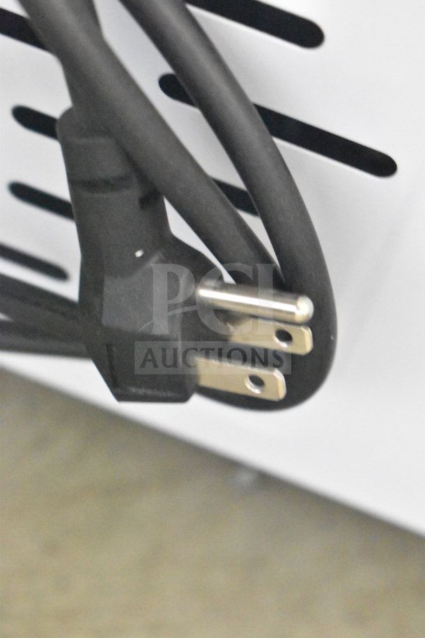 Close-up image of the power cord and plug for the Avantco 360ADCGEL9 Gelato Dipping Cabinet, 115 Volts, 1 Phase.
