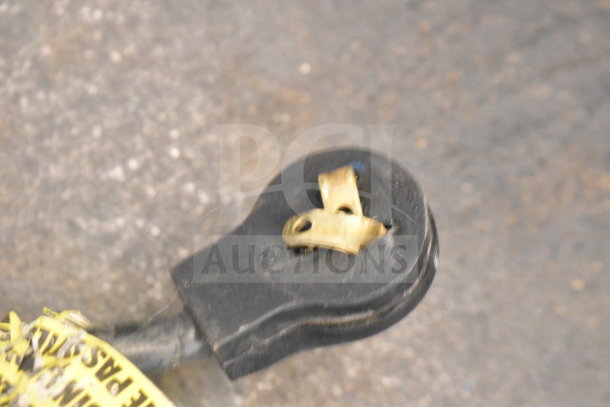 Close-up of an electrical plug associated with the Imbera EVC04 Commercial Mini Cooler Merchandiser, 115 Volts, 1 Phase.