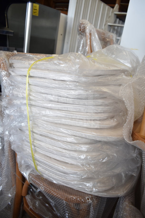17 new Flash Furniture wood pattern cross-back chairs and cushions, wrapped in plastic, showing minor scratches and dents.