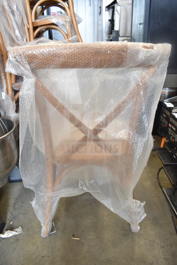 Flash Furniture wood-pattern cross-back chair, wrapped in bubble wrap; new with minor scratches and dents, cushions included.