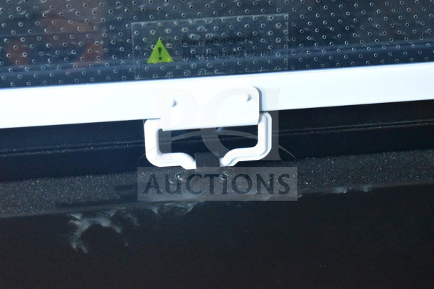 Brand new Avantco 193VAC46B 45.5" black refrigerated air curtain merchandiser latch detail. Scratch and dent model.