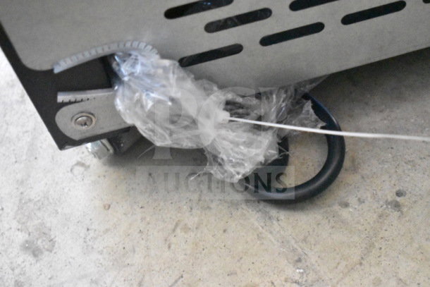 Avantco 193VAC46B merchandiser wheel area with protective plastic and cable tie visible, indicating new condition.