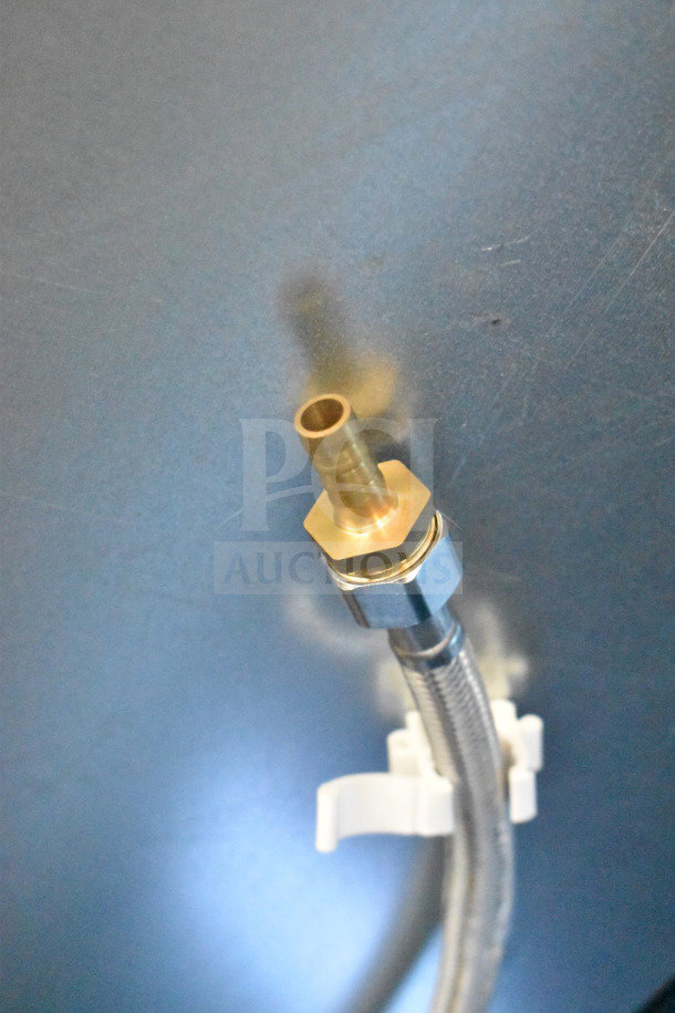 Close-up of a metal fitting and hose connection on the Avantco 193VAC46B refrigerated air curtain merchandiser.