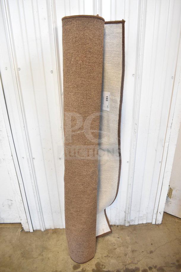 Mainstays Pecan Rug 60"x84", rolled. Textured brown surface, new condition. Tag marked "193, Qty 1."