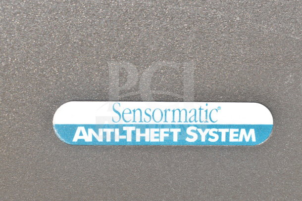 Sensormatic anti-theft system label on a device, indicating AMS-113 split detector; part of 18-item auction lot.