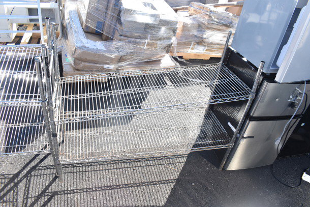 Two chrome finish wire shelves in excellent condition, multiple tiers, sturdy design, suitable for storage or display.