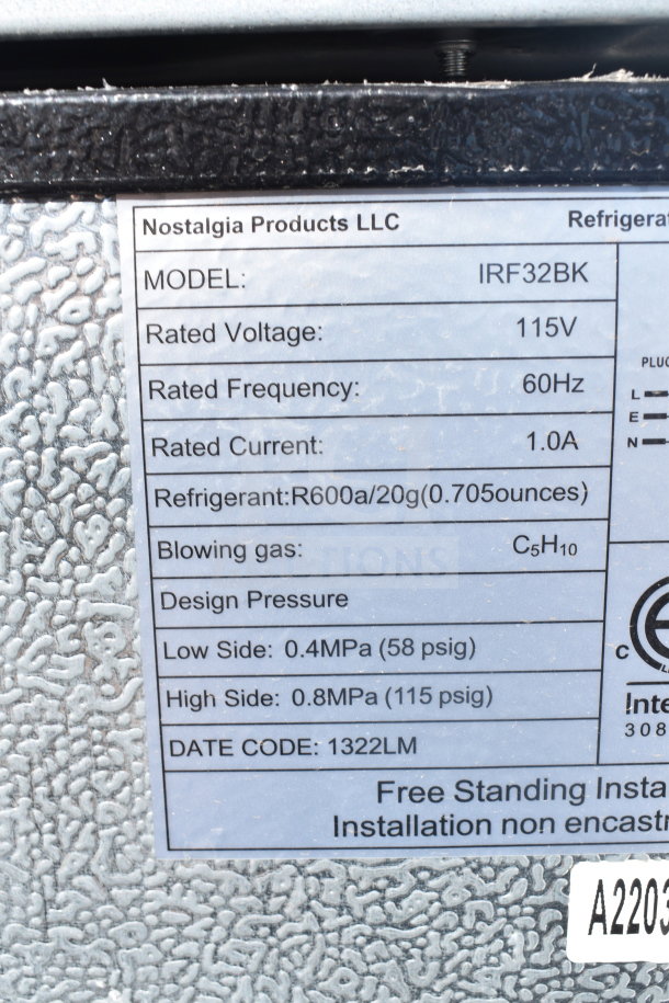 Label on mini cooler showing Nostalgia Products LLC model IRF32BK, 115V, 60Hz, using R600a refrigerant.