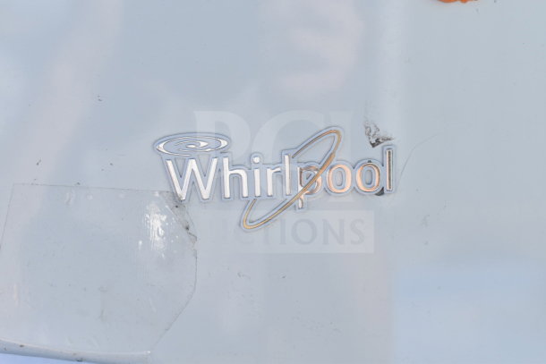 Whirlpool WRT511SZDW00 cooler and freezer logo, visible wear on surface, model identification for auction.