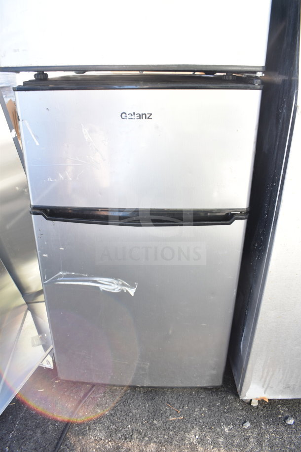 Two mini coolers, including Galanz brand, silver finish, used condition, 120 volts, with visible scratches and tape marks.